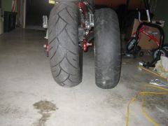 stock tire on right on stock rim, left is new rims with new tires.